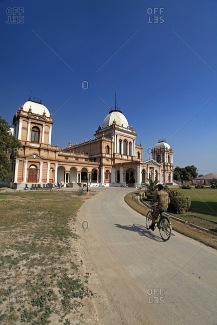 Man on bike approaching the Noor Mahal palace in Bahawalpur, Pakistan