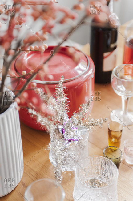 Tinsel decorating a table covered with glasses