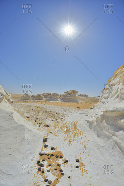 Sun over rock formations in White Desert, Sahara Desert
