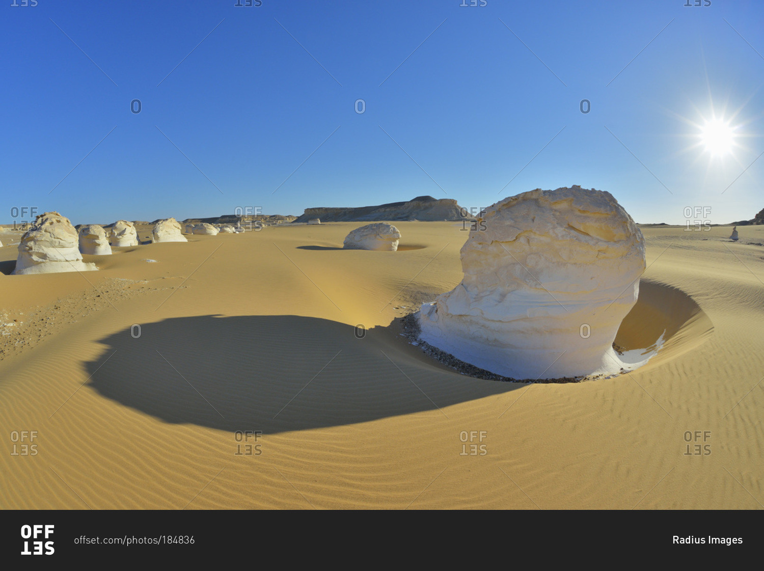 Sun over rock formations in White Desert, Sahara Desert