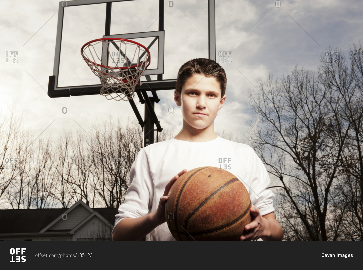 Portrait of teenage boy with a basketball