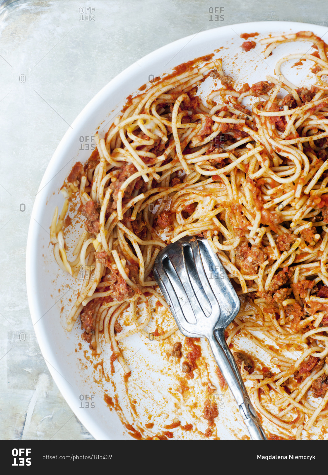 Fork and spoon on half eaten plate of spaghetti stock photo OFFSET