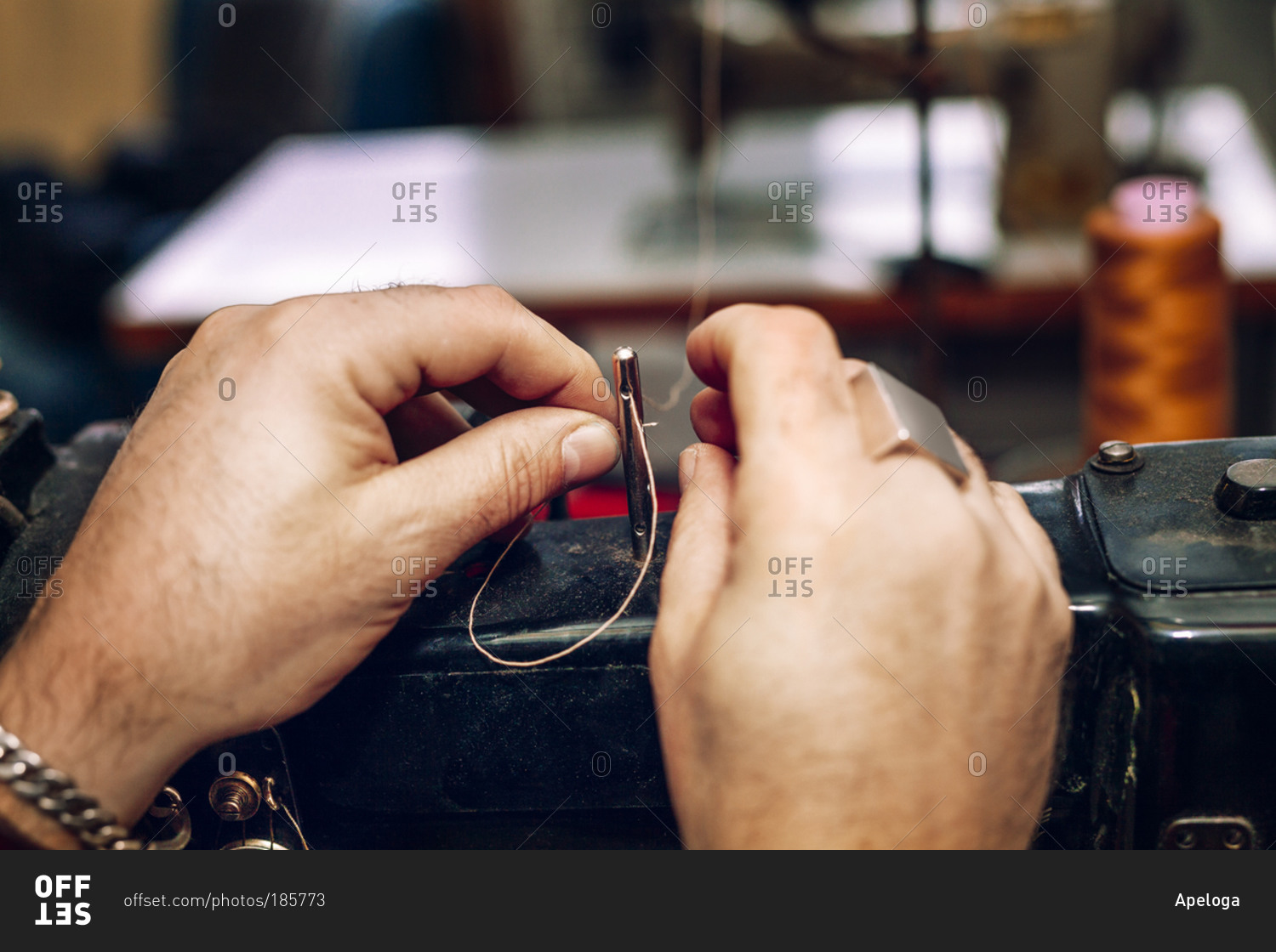 A craftsman threads a sewing machine