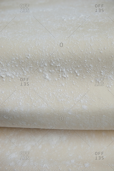 Flour on a sheet of pastry dough