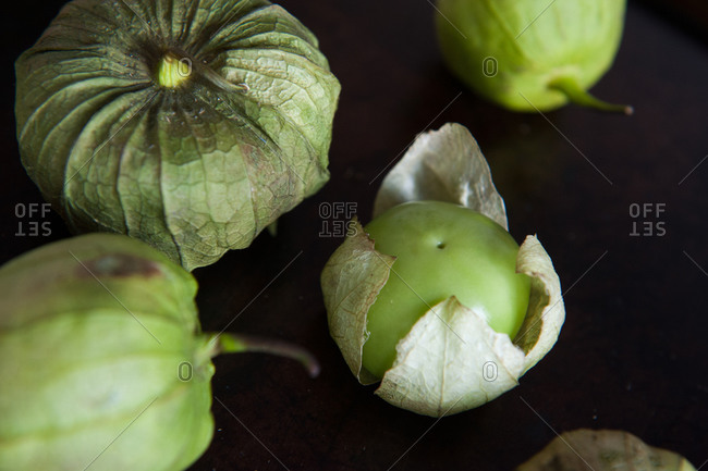 Tomatillos on a dark background