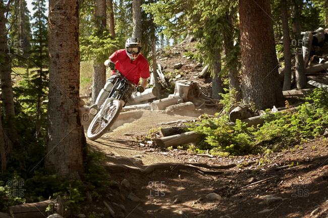 Downhill biker riding on a forest track