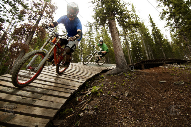 Bikers racing down an obstacle course