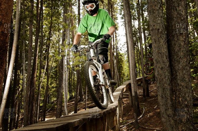 Mountain biker racing down a track