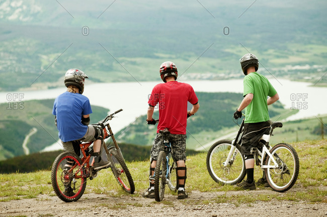 Three mountain bikers enjoying the view