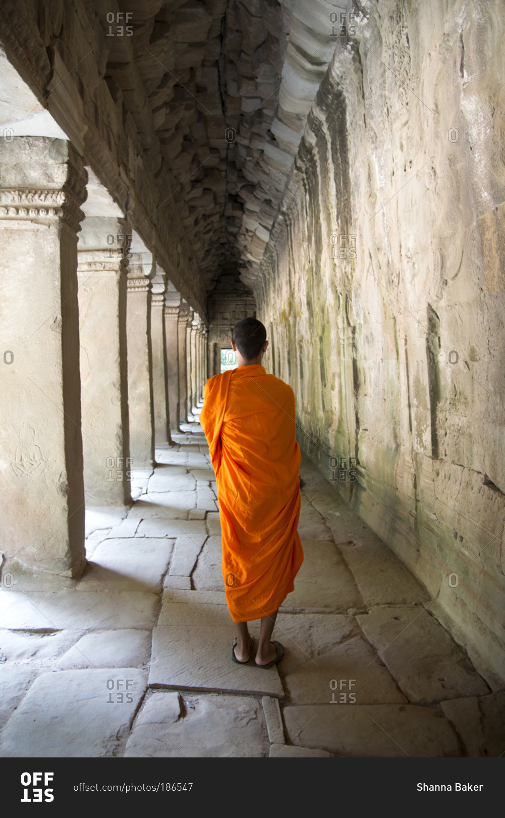 Monk wandering Angkor archeological complex