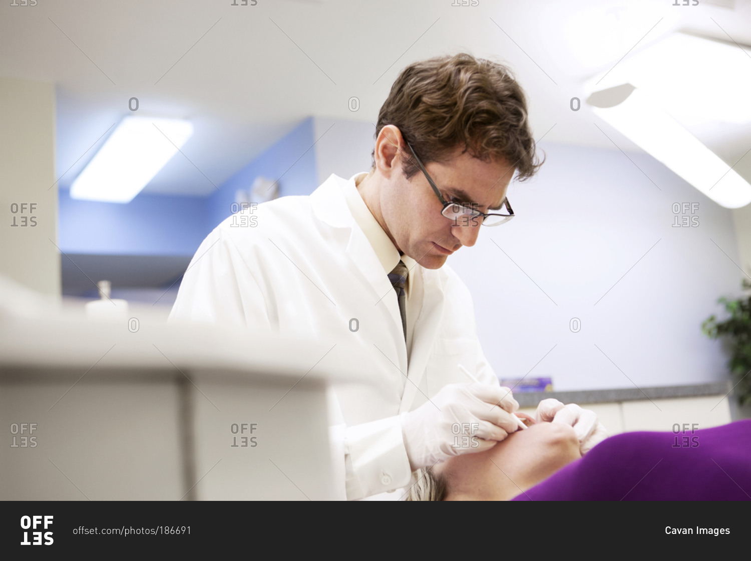 Dentist checking the teeth of a patient