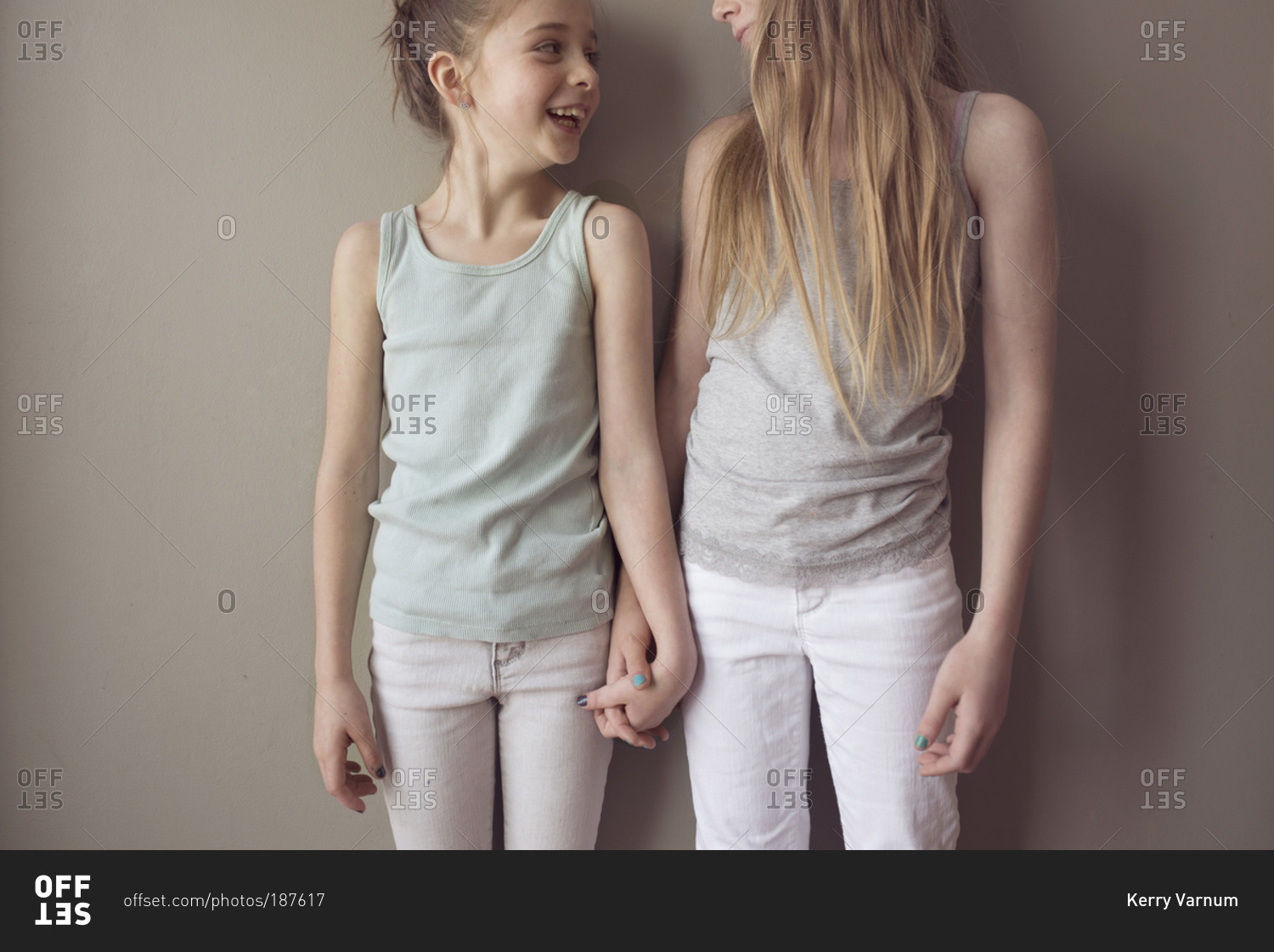 Young girls holding hands stock photo OFFSET