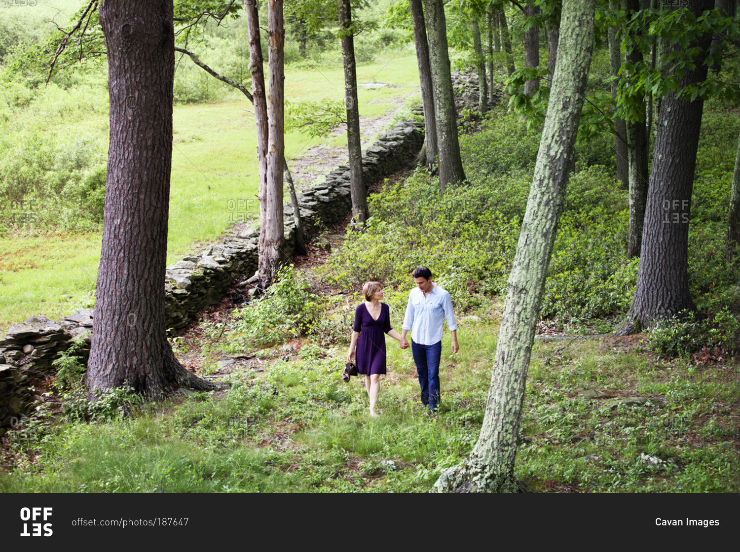 Mature couple talk while walking in the woods