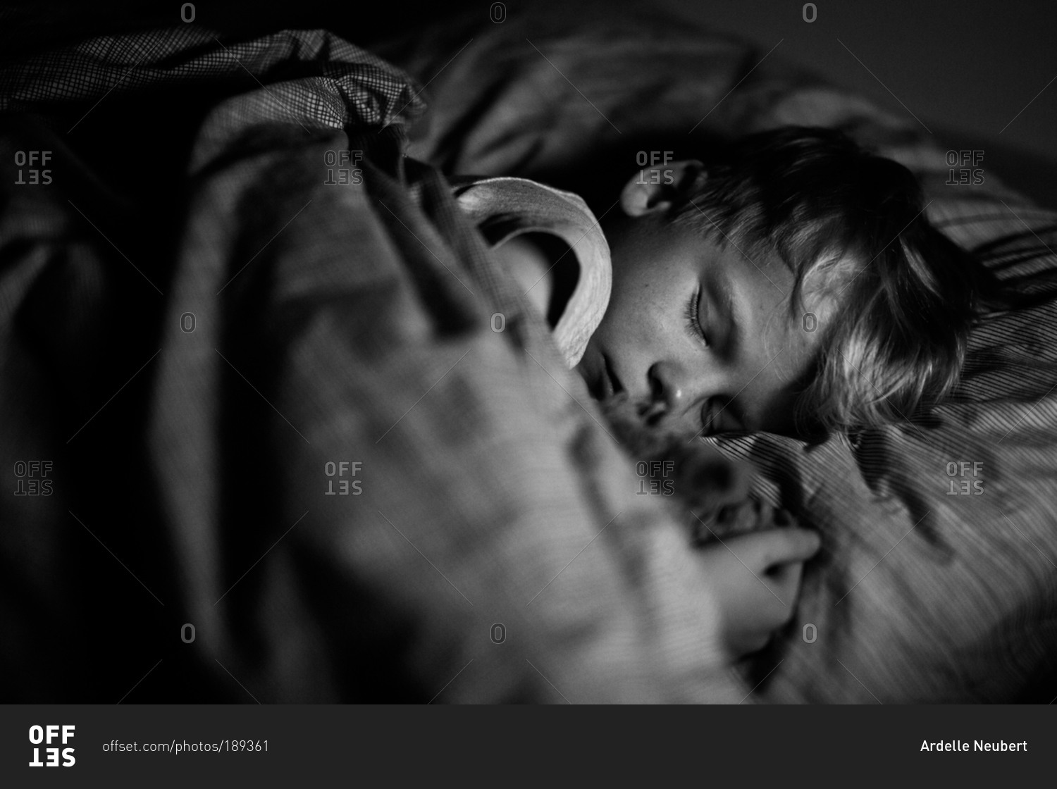 young-boy-sleeping-in-a-bed-stock-photo-offset