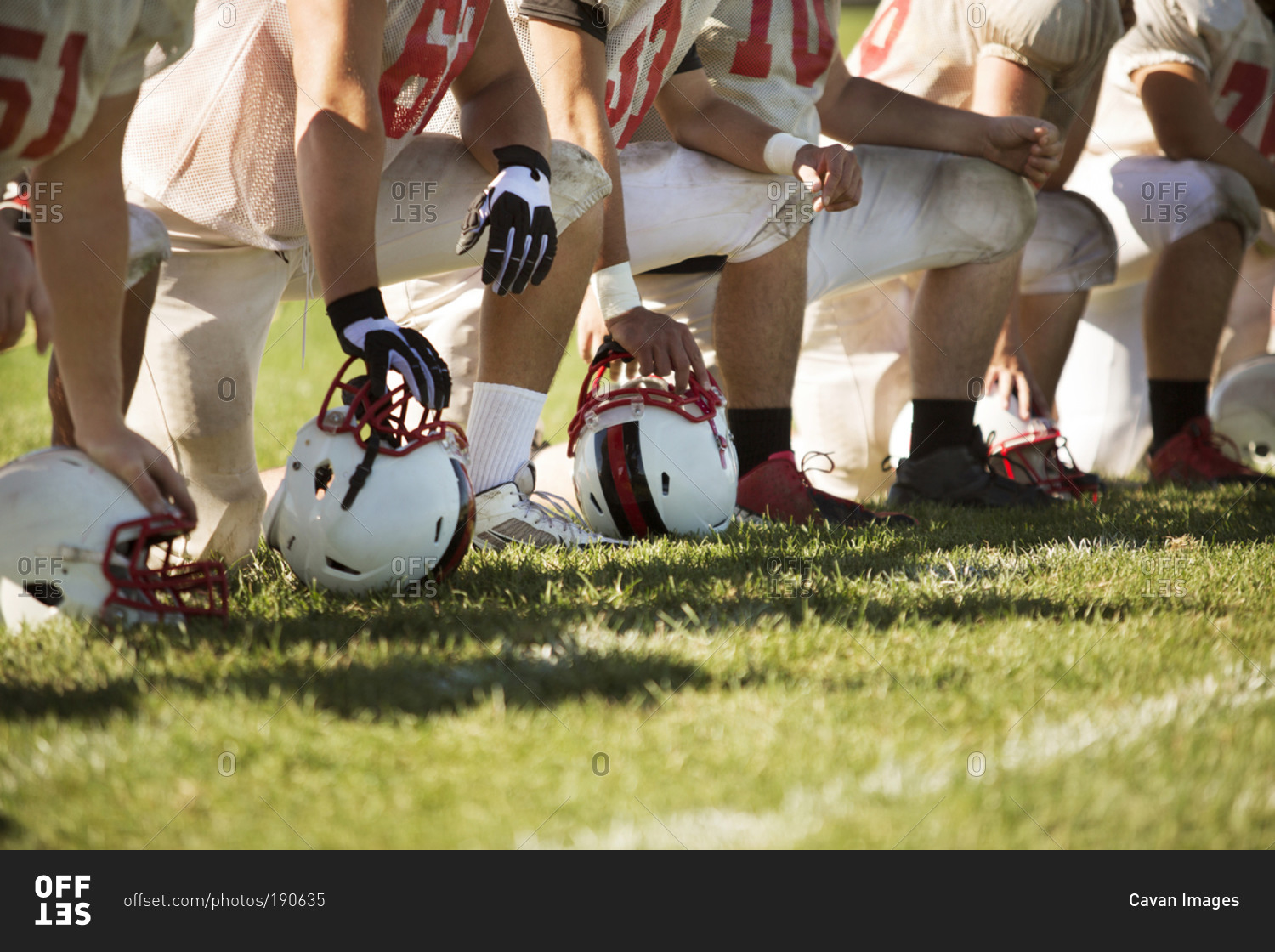 A high school football team takes a knee