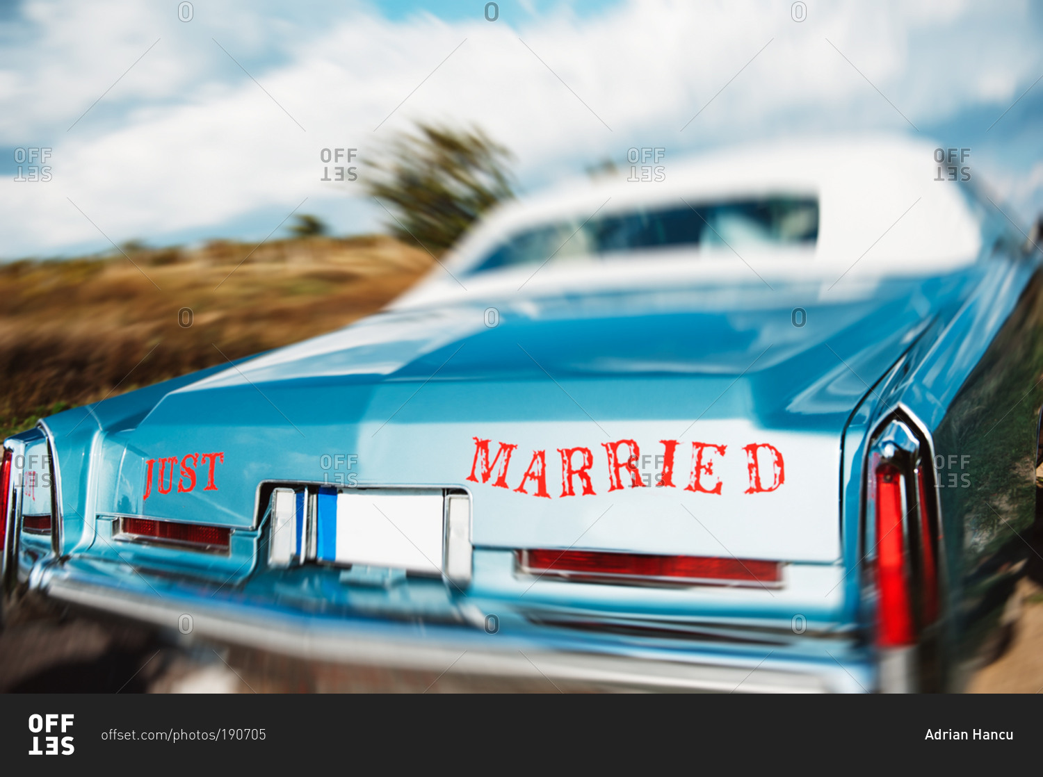 The Just Married signage on the back of an American vintage car