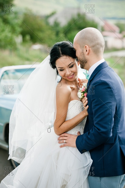 Groom kissing lovingly the bride