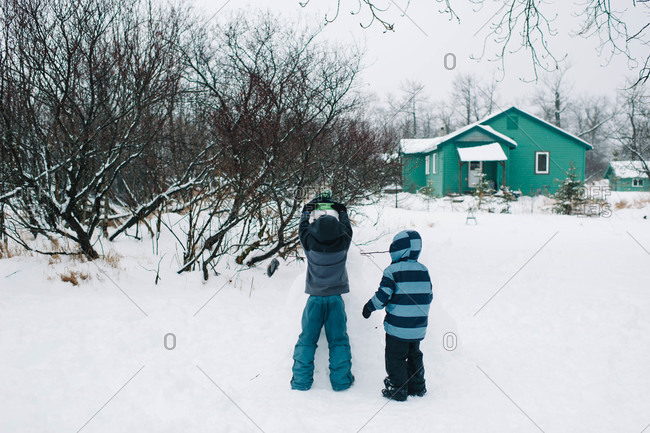 building a snowman stock photos - OFFSET