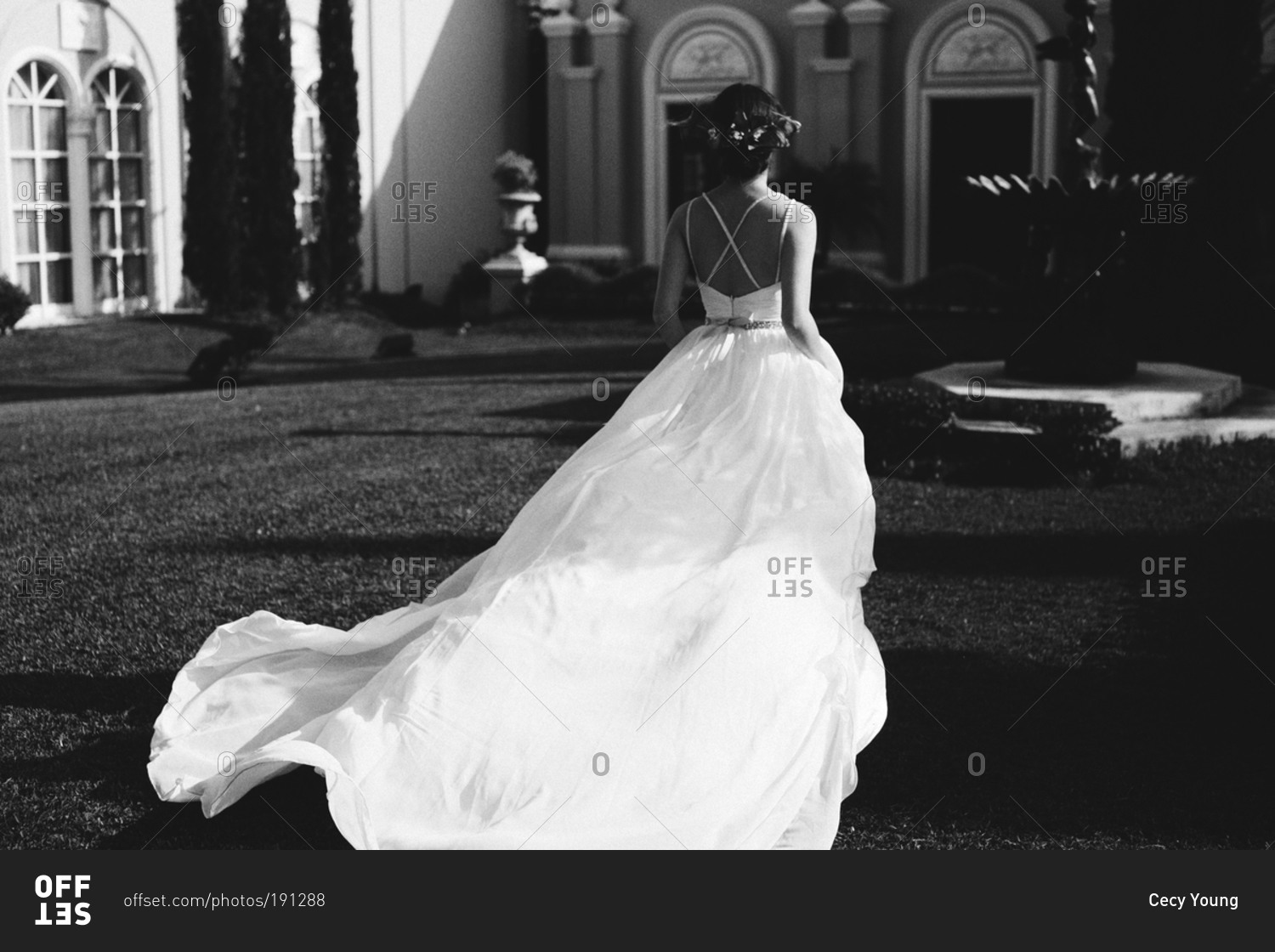 Bride in courtyard in flowing dress