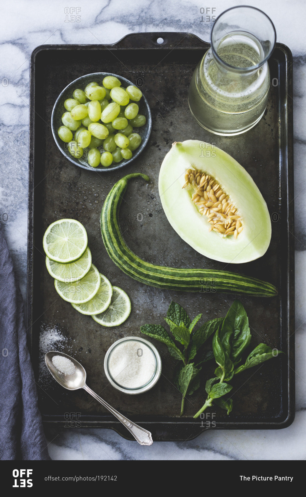 Green fruits and vegetables on a baking tray