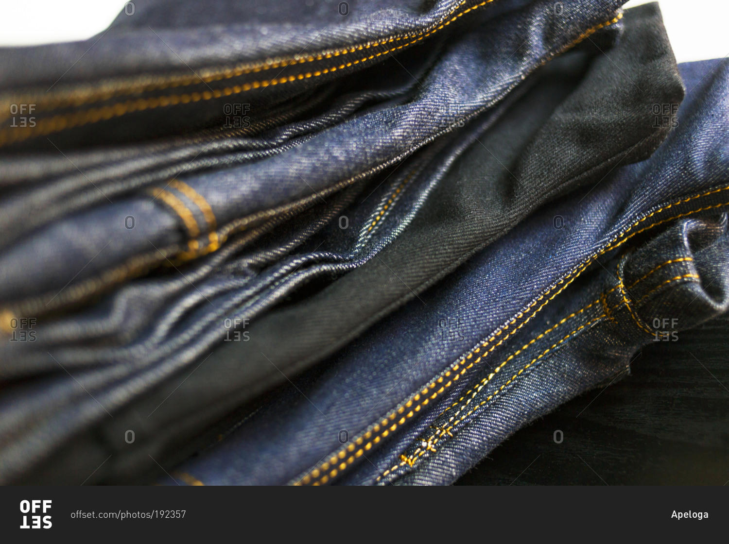 Close-up of stack of folded jeans stock photo - OFFSET