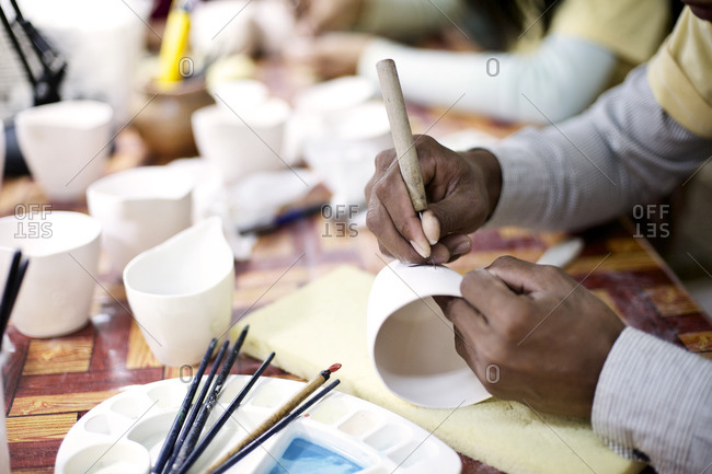 Person engraving a cup