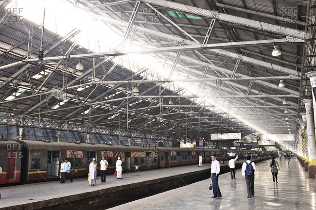 Mumbai, India - February 7, 2015: People waiting for a train at a station