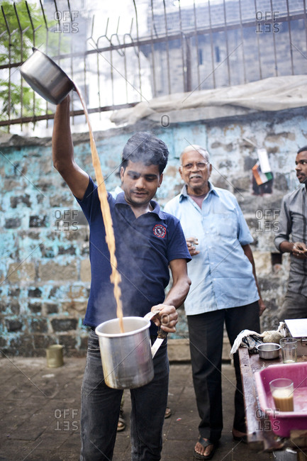 Mumbai, India - February 8, 2015: Tea vendor preparing masala chai