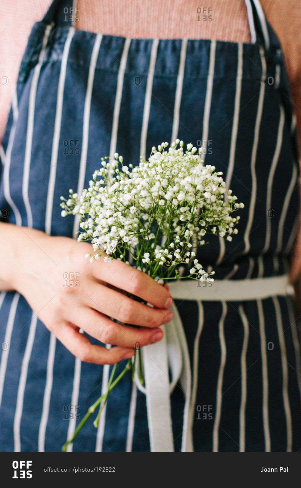 Woman holding a bunch of baby's breath flowers