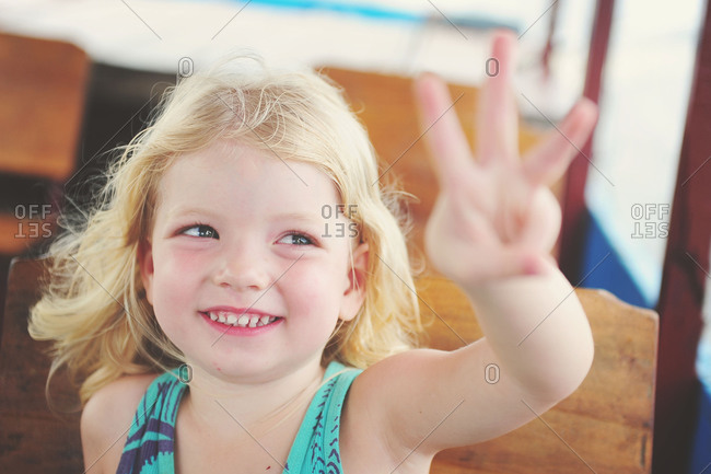 girl holding up 3 fingers pinterest