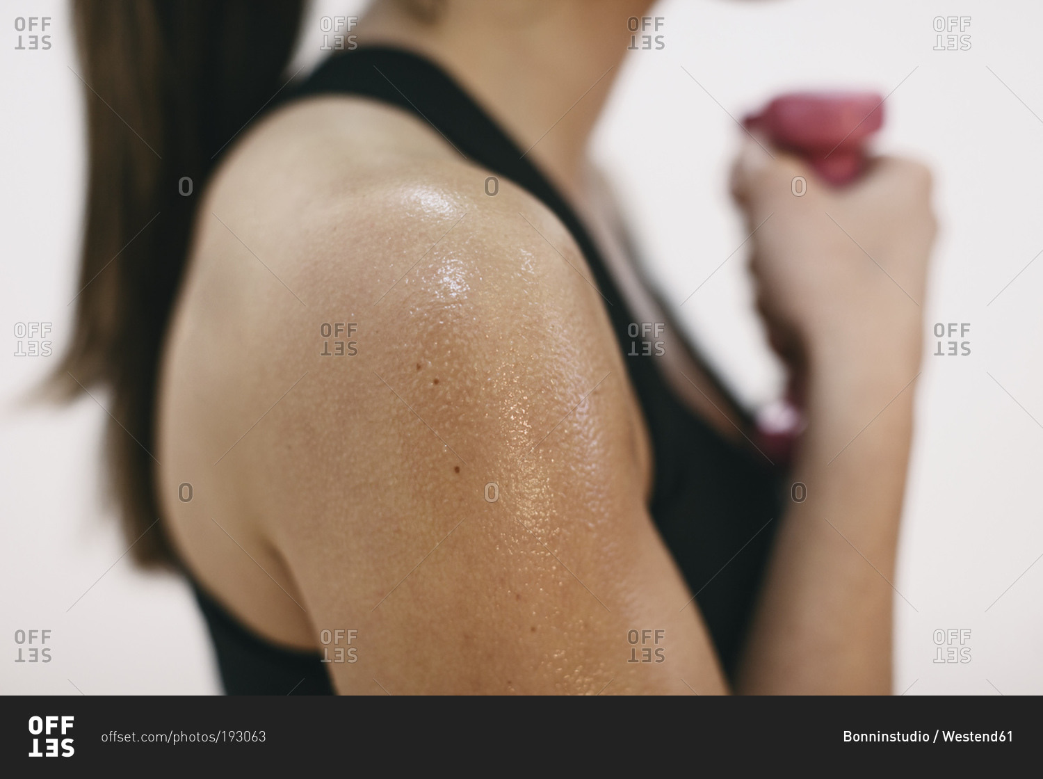 Sweaty shoulder of woman doing fitness workout