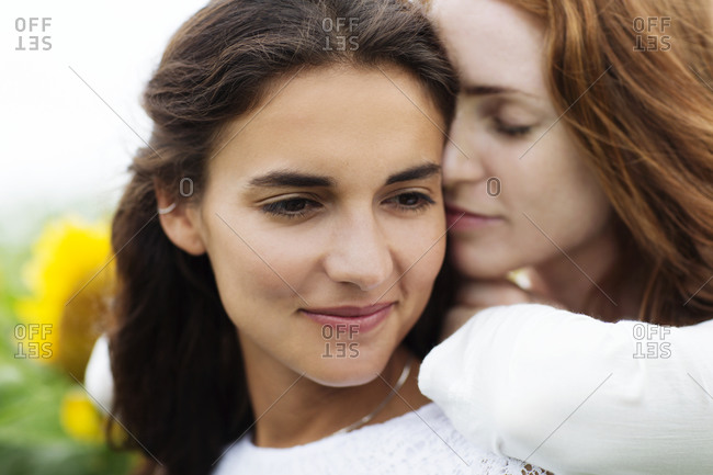 Woman cuddling up to her friend