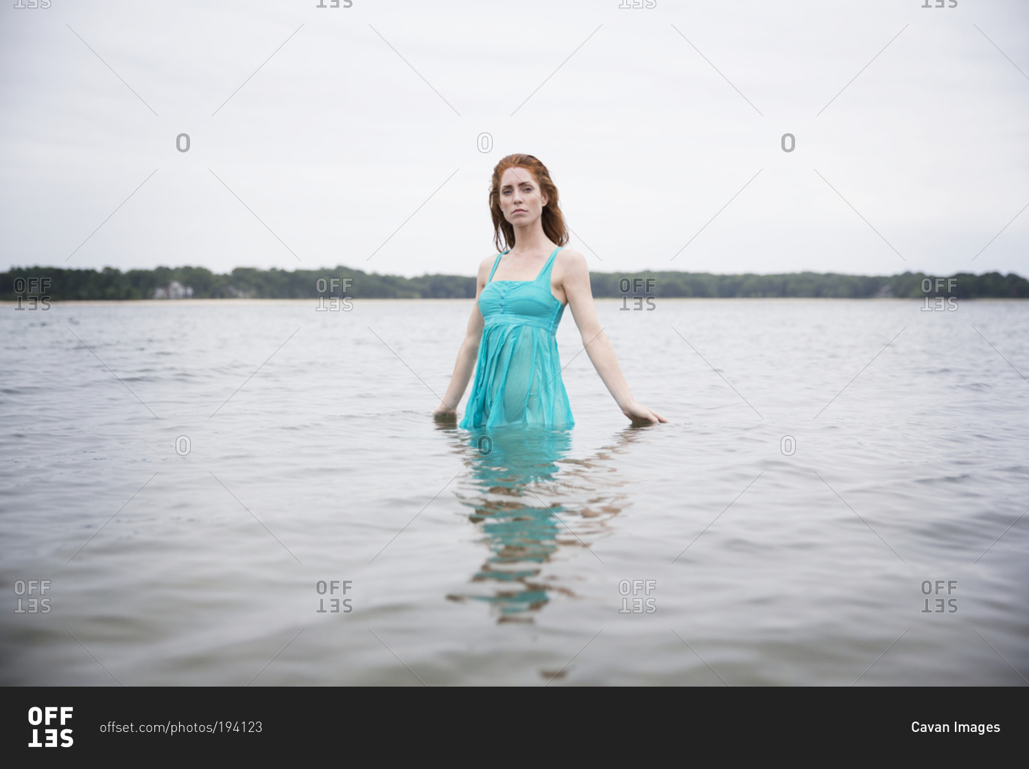 Fully Dressed Woman Wading Into The Water Stock Photo Offset