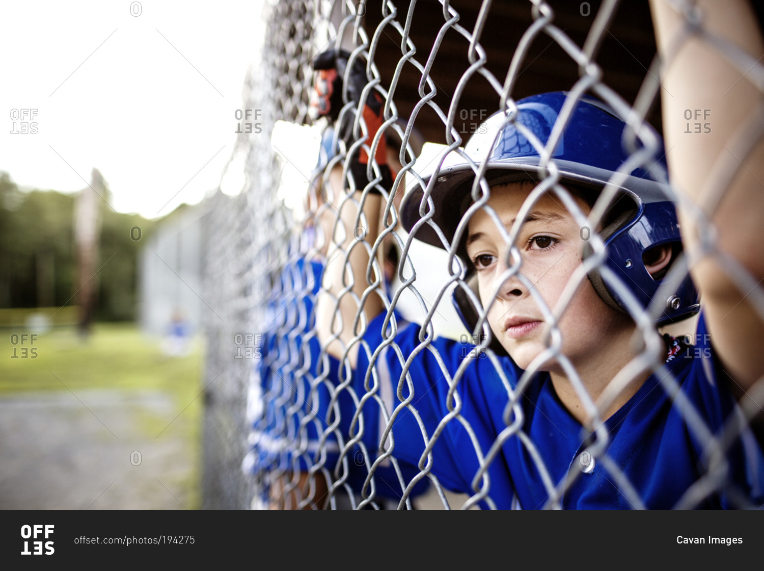 A boy watches his baseball team play