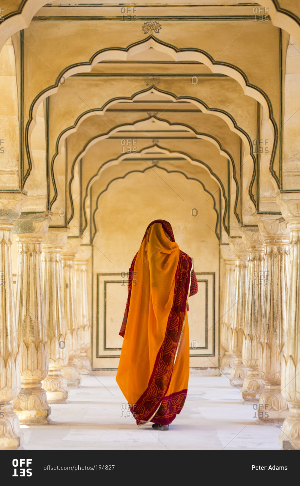 Indian woman walking along a passageway in Amber Fort, Jaipur, Rajasthan, India