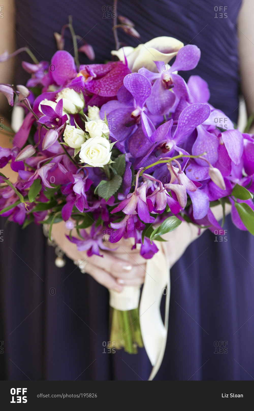 A bridesmaid's bouquet of purple flowers