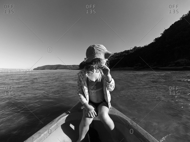 Girl seated on bow of canoe