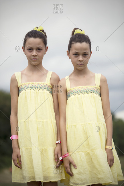 Twinsburg, Ohio - August 5, 2012: Identical twin sisters in yellow dresses at the annual Twins Days Festival