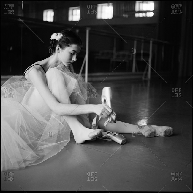 Ballet dancer putting on shoes