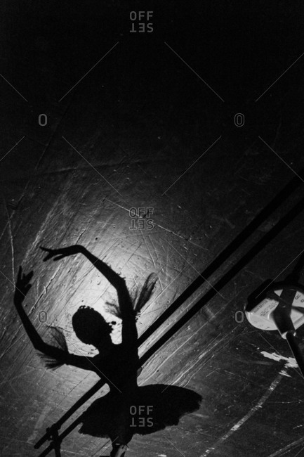 Shadow of a ballerina on the floor of a dance studio