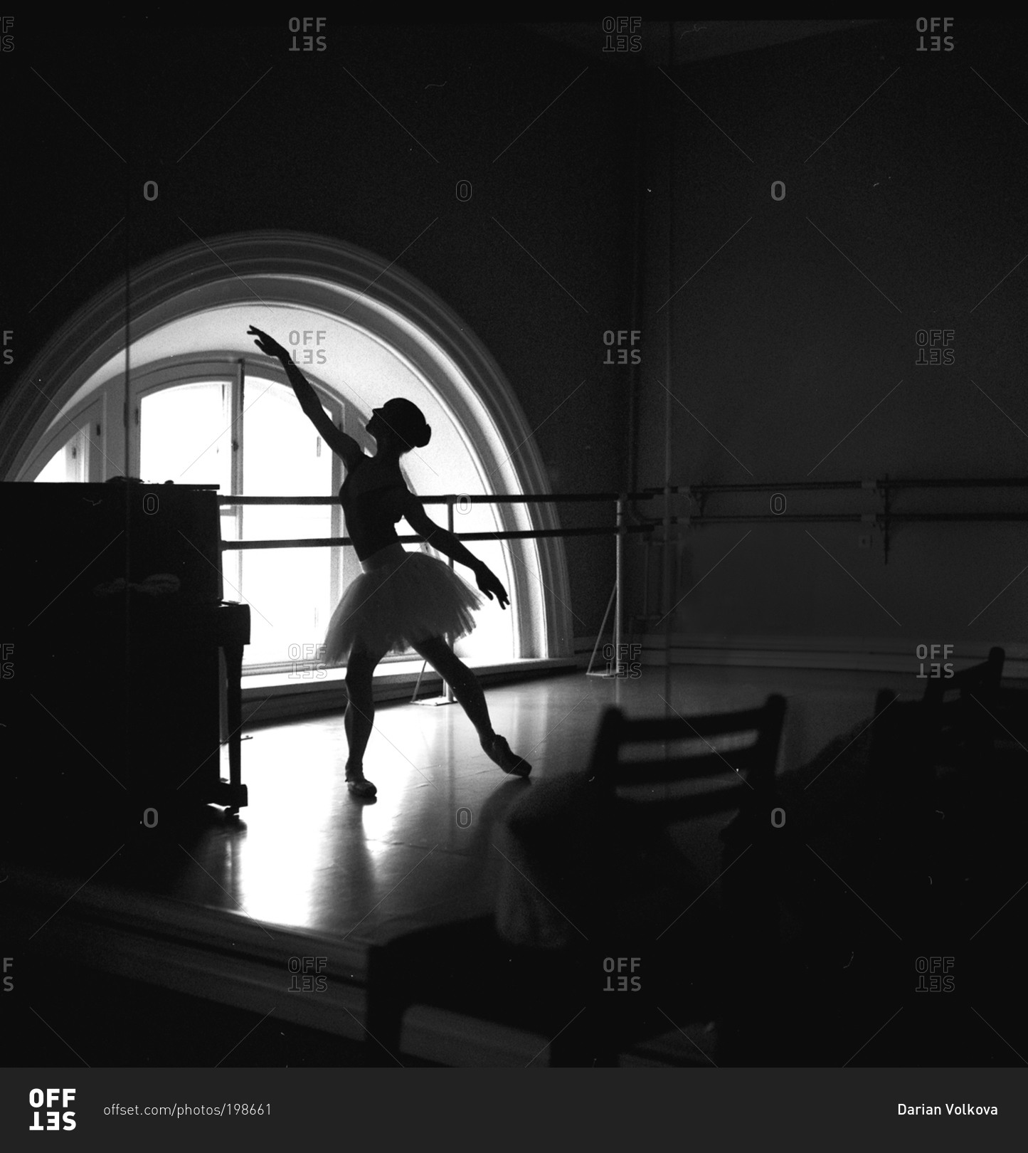Silhouetted dancer practicing in studio