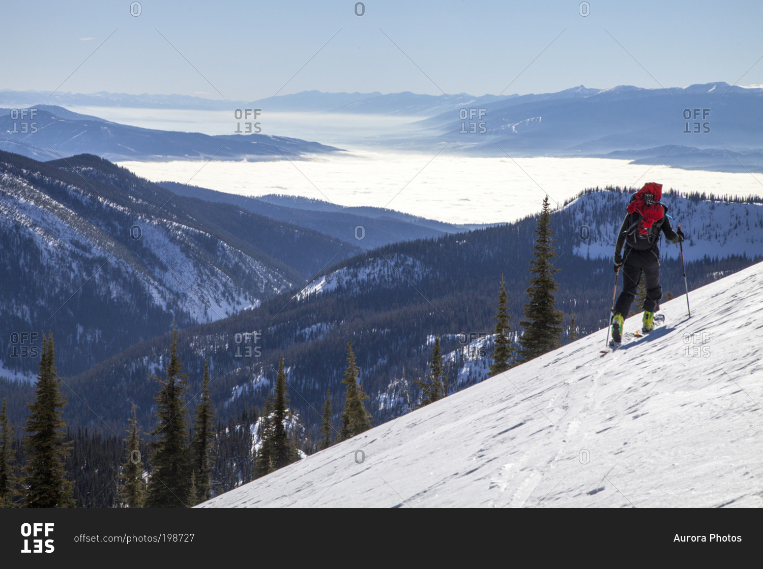 A backcountry skier tours through the Rattlesnake Mountains high above an inversion in the Bitterroot and Missoula Valley, Montana