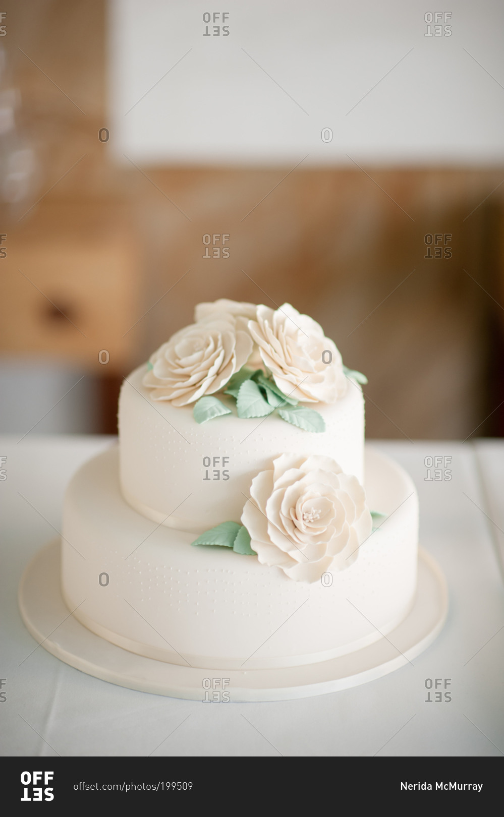 Tall-layered two-tier buttercream wedding cake with cascading flowers.  Vegan. - Picture of City Cakes & Cafe, Salt Lake City - Tripadvisor