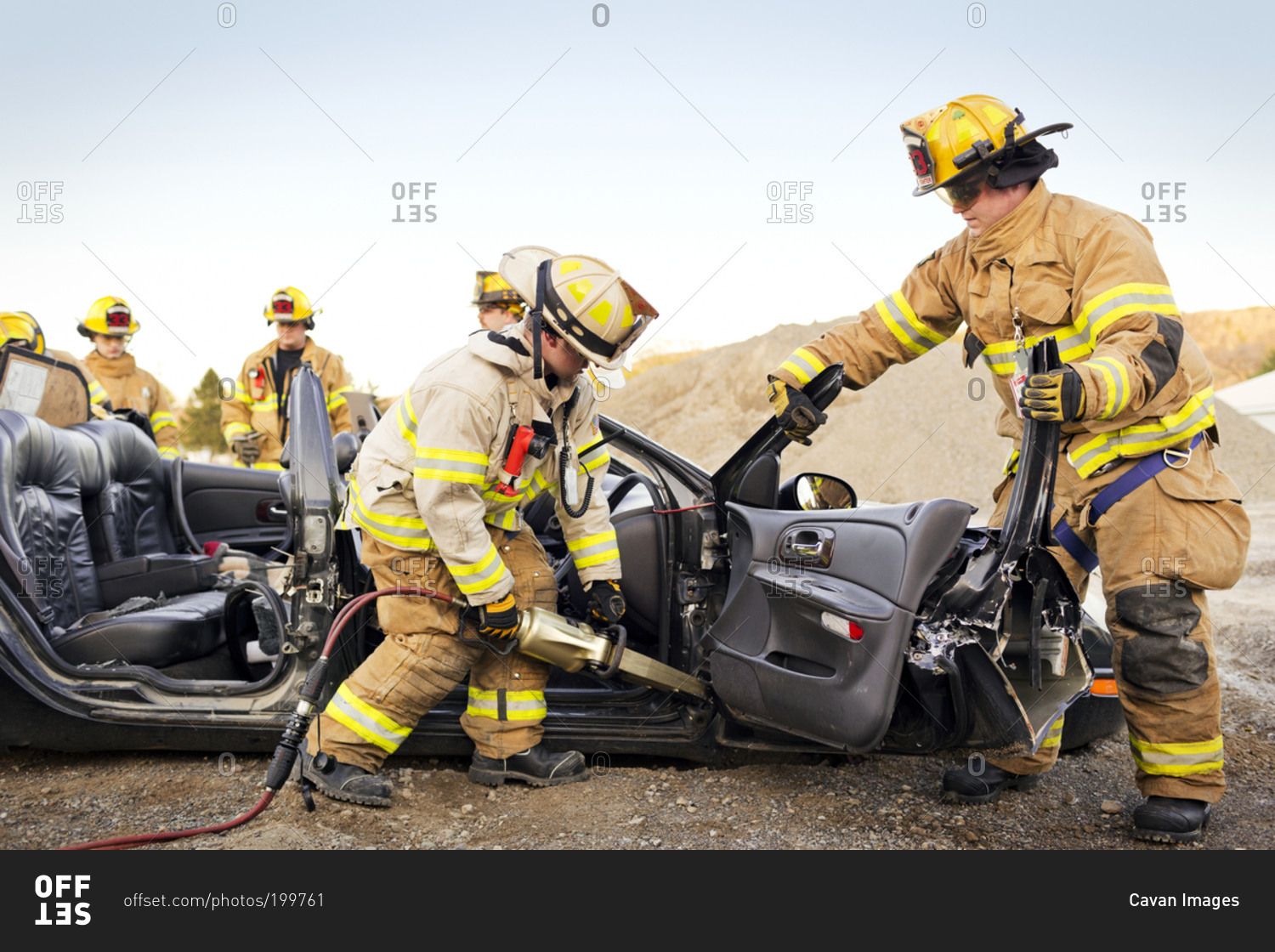 Firemen practice disassembling a car