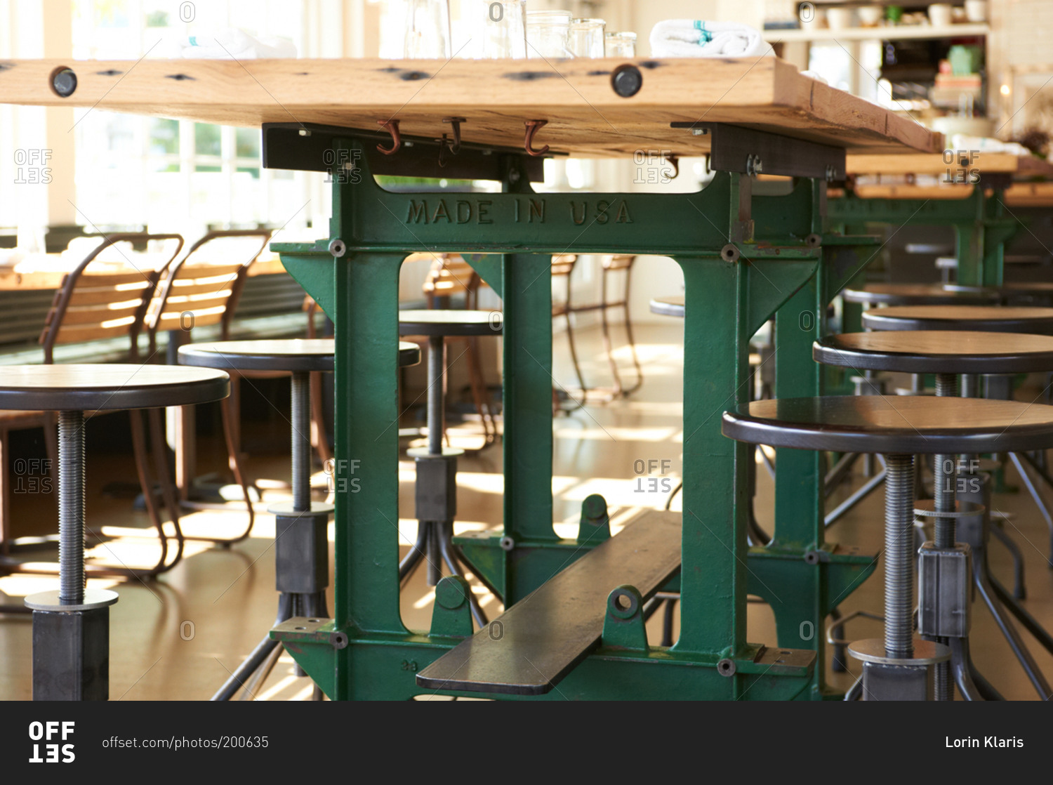 Industrial-style workbench and stool seating in a casual restaurant