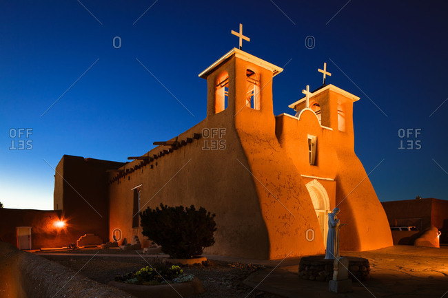 Exterior of the San Francisco de Asis Church at night in Ranchos de Taos, New Mexico, USA