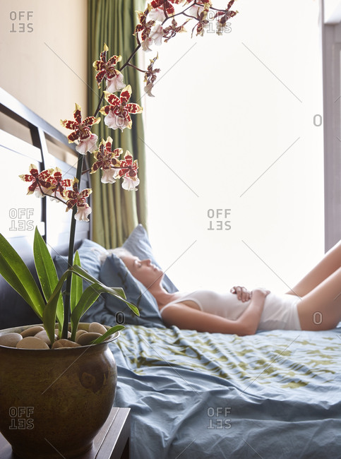 Woman with grey hair sleeping in bed