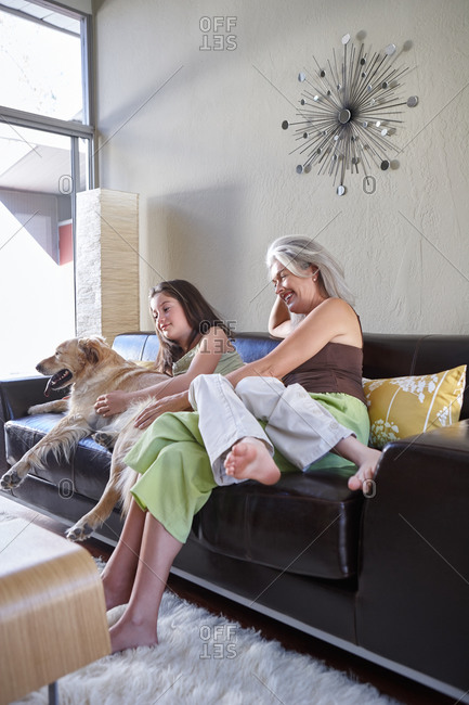 Mother and daughter in living room with dog