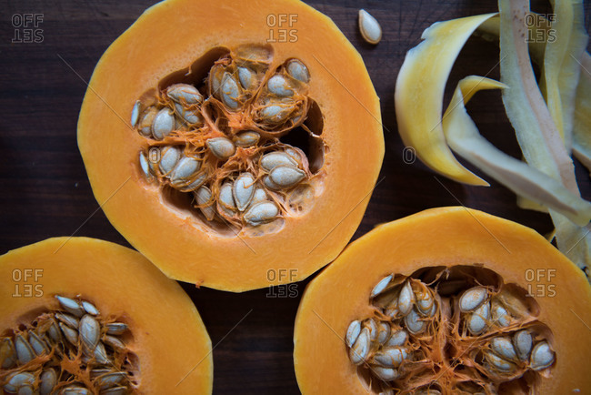 Slices of butternut squash on a wooden board