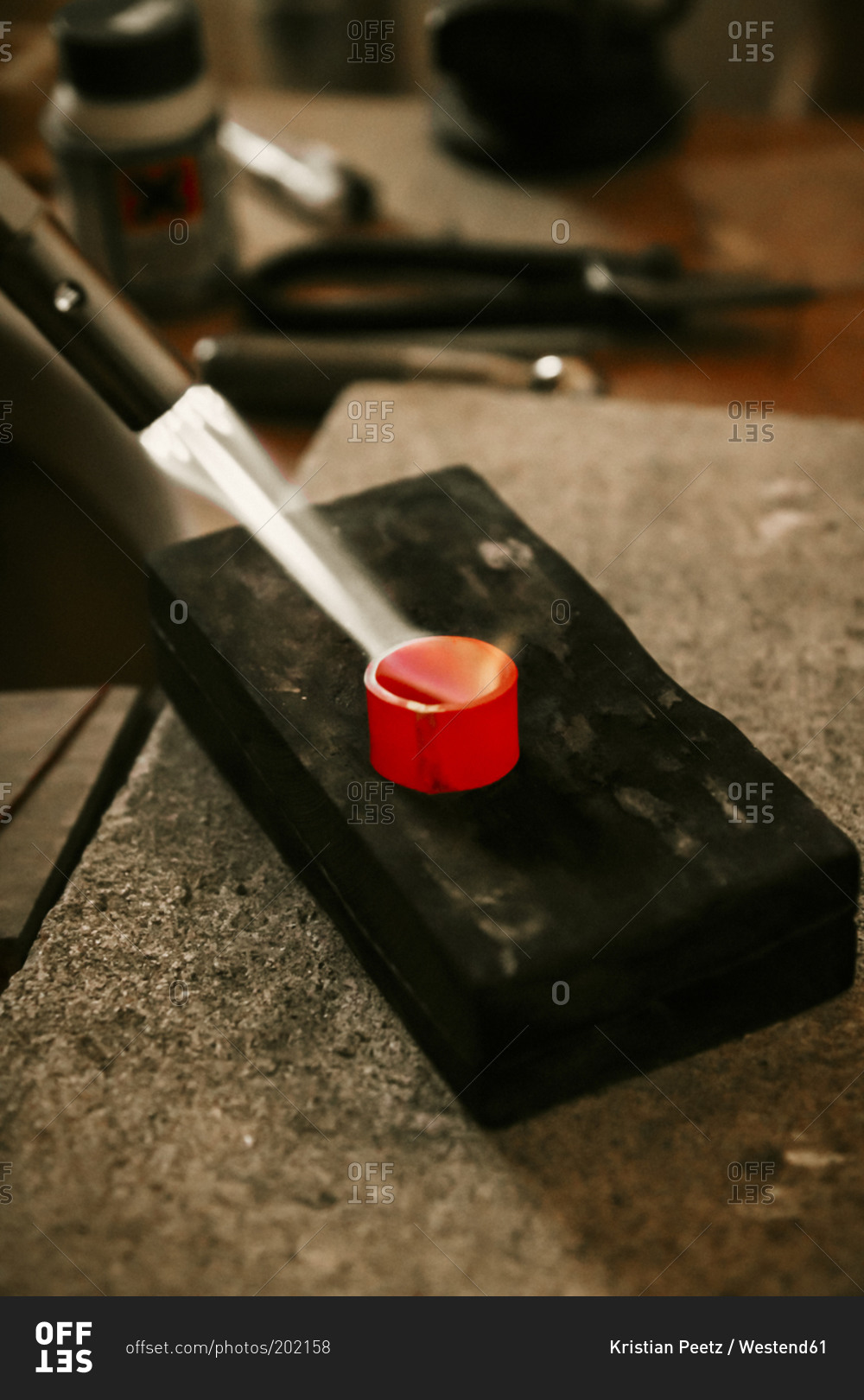 Goldsmith working with Bunsen burner on work piece stock photo OFFSET